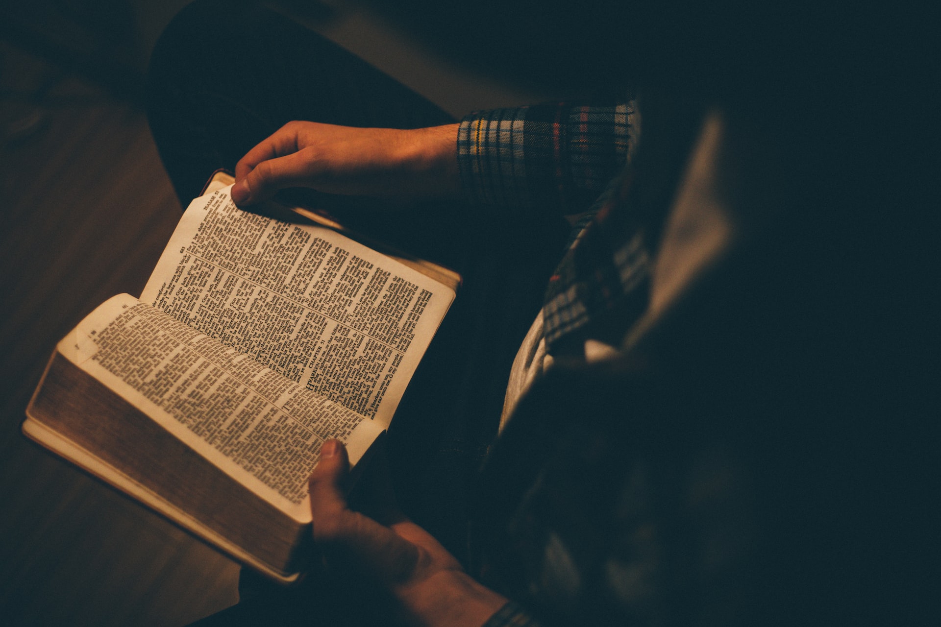 Person holding open bible